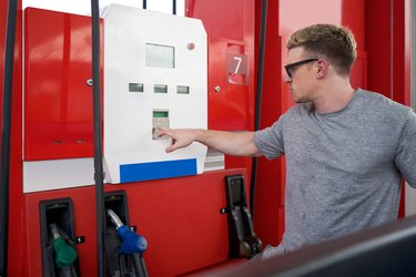 young man at gas pump