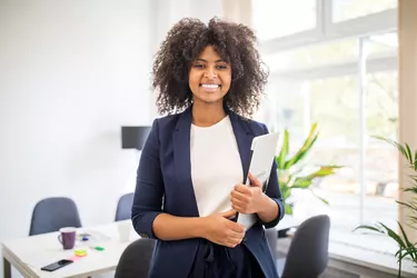 Portrait of confident african businesswoman with laptop