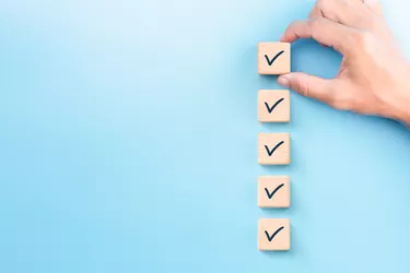 Checklist concept, Check mark on wooden blocks, blue background with copy space
