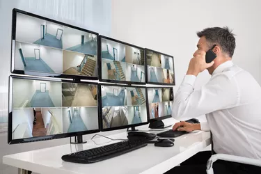 Security System Operator Looking At CCTV Footage