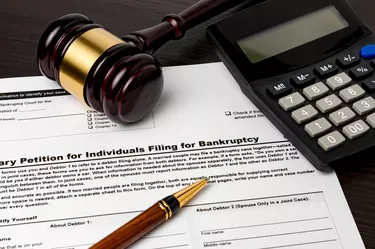 Bankruptcy petition for individuals with calculator and gavel. Concept of financial and unemployment crisis, personal debt, economy and recession.