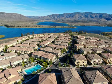 Aerial view of identical residential condo with big lake and mountain on the background, California