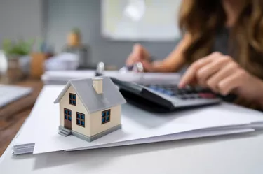 Businesswoman's Hand Calculating Invoice