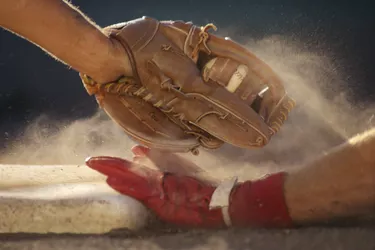 Baseball player sliding into base, baseman tagging player, close-up