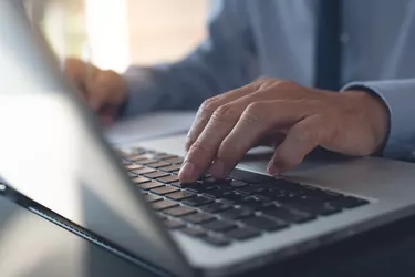 Businessman working on laptop in office