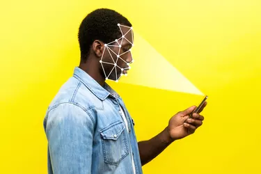 Mobile biometric identification and verification or detection concept. face ID scaning or unlocking technology. serious man using facial recognition on smartphone.