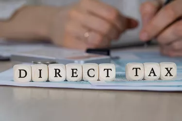 Word DIRECT TAX composed of wooden dices.