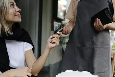 Close-up of waitress taking a cashless payment