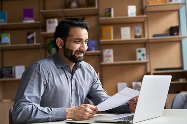 business man hr employer, teacher or lawyer holding cv document having virtual job interview meeting by video conference call