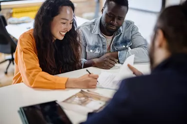 The couple signs the documents. Client consultation