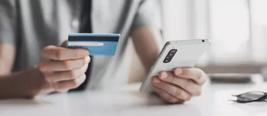 Man paiyng online using smartphone and credit card