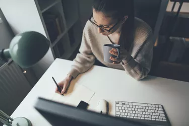 Young woman working long hours at her home office