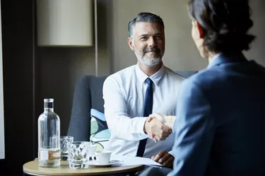 Business people shacking hands after meeting