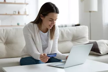 Young woman pay online using credit card