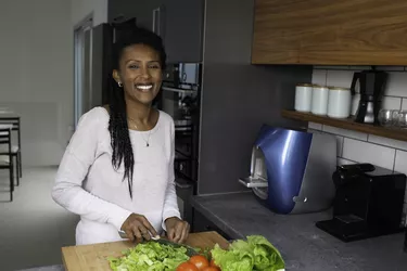 Woman cutting salad leaves.