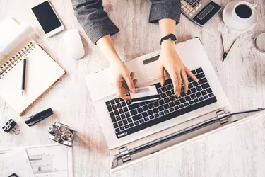woman hand credit card with keyboard on table