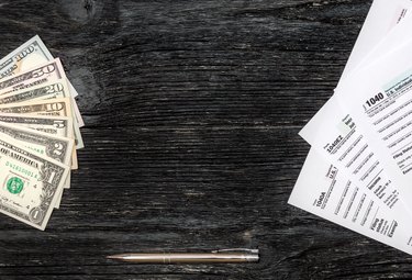 Frame from money and tax form on the wooden background