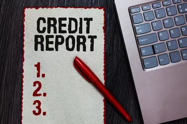 Handwriting text writing Credit Report. Concept meaning Borrowing Rap Sheet Bill and Dues Payment Score Debt History Piece paper red borders black marker computer keyboard wooden background.