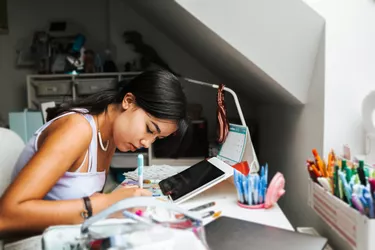 female hispanic teenager doing some homeworks during online classes