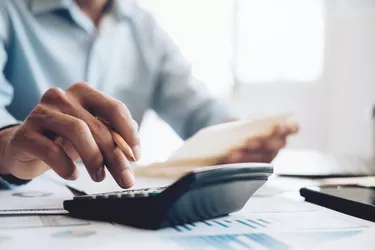 Male accountant or banker use calculator.