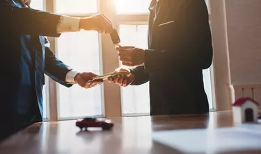 Car leasing concept. Business people pay and received the car keys.