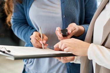 New Car Owner Signing Contract