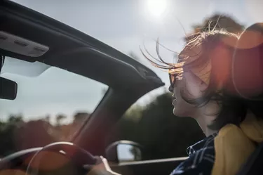 Woman driving convertible car