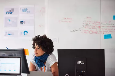 Businesswoman at desk working on computer