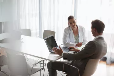 Businessman working with scientist in conference room