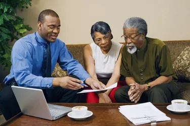 Couple with businessman discussing finances
