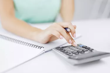 businesswoman working with calculator in office