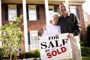 Couple with sold sign