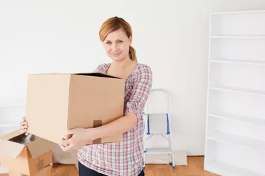 Attractive woman carrying cardboard boxes