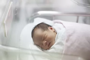 face of first day new born in hospital delivery room