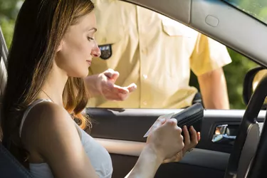 Police - woman in traffic violation getting ticket