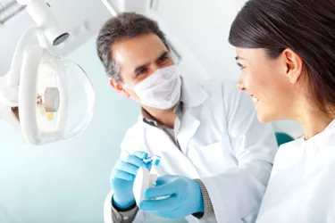 Dentist showing how to brush teeth
