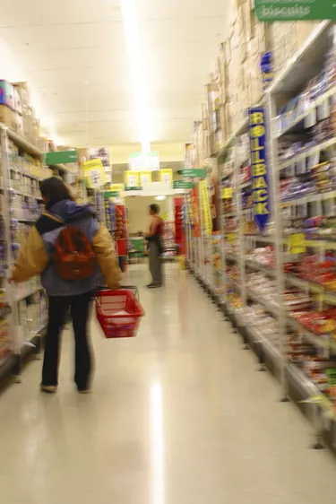 A typical Melbourne Supermarket. A shopper awaits their groceries to be put through the checkout.  2003