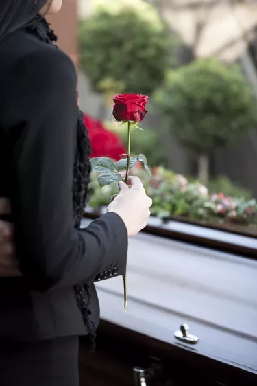 Woman at Funeral with coffin