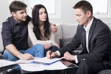 Agent advises the couple, signing documents