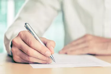 Hand signing a document