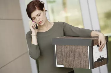 Businesswoman Using Mobile Phone with Moving Box