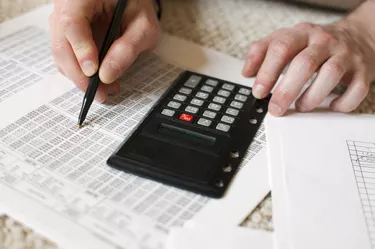 Man's hands and calculator