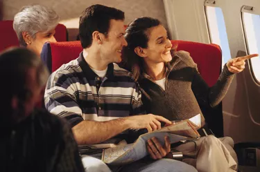 Couple looking out window of airplane