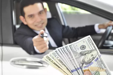 Man giving car key exchanging with money - car pawn