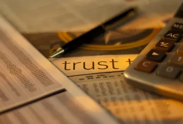Trust papers with calculator and pen