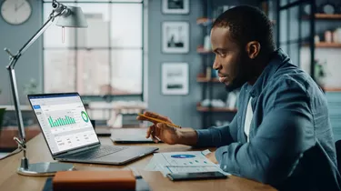 Specialist Working on Laptop Computer