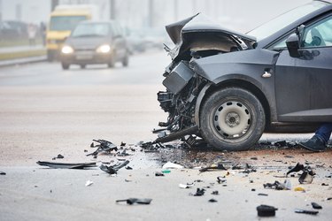 Car crash in urban street with black car